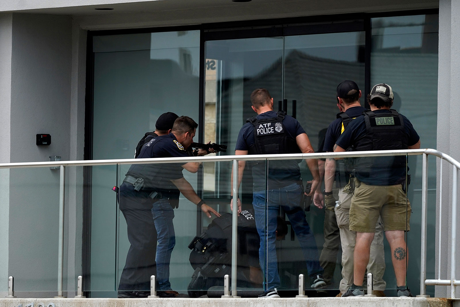 Law enforcement search a building after a shooting at the Highland Park Independence Day parade in Illinois on July 4.