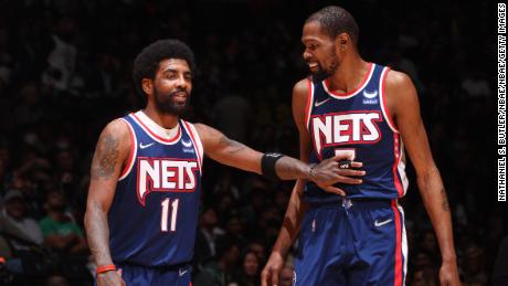 Kyrie Irving talks to Durant during Game 4 of the Eastern Conference first round in the 2022 NBA Playoffs.