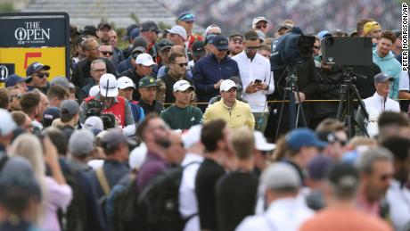 McIlroy and Morikawa look along the 5th fairway during the first round.