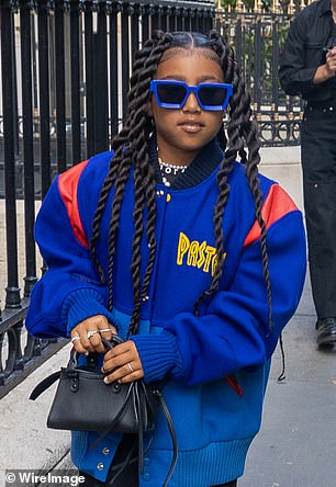 North West, nine, wears dad Kanye’s vintage jacket and designer accessories