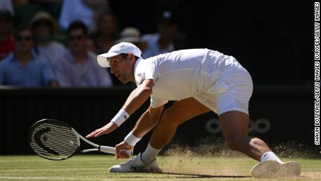 Djokovic slides for a shot against Norrie during their Wimbledon quarterfinal. 