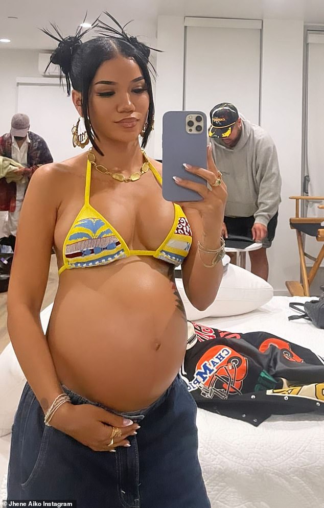 Pregnant Jhene Aiko showcases her baby bump in yellow bikini top