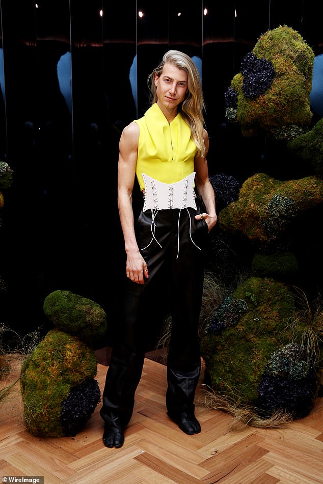 Richard Wilkins’ son Christian shows off his VERY buff biceps in a yellow corset at fashion launch