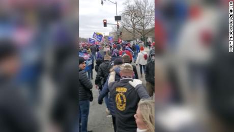 Courtney Holland, right, can be seen walking toward the US Capitol on January 6, 2021, with her hand on the shoulder of an Oath Keeper. 