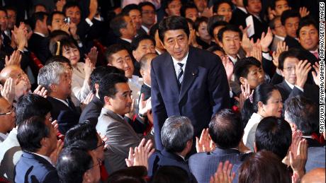 Abe bows to applause from lawmakers of the ruling Liberal Democratic Party after winning the party&#39;s presidential election on Sept. 20, 2006. 