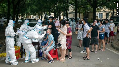 Residents line up to be tested for Covid-19 in Wuhan, central China&#39;s Hubei province on August 3, 2021. 