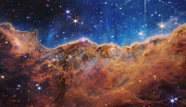 Webb reveals cosmic cliffs, glittering landscape of star birth