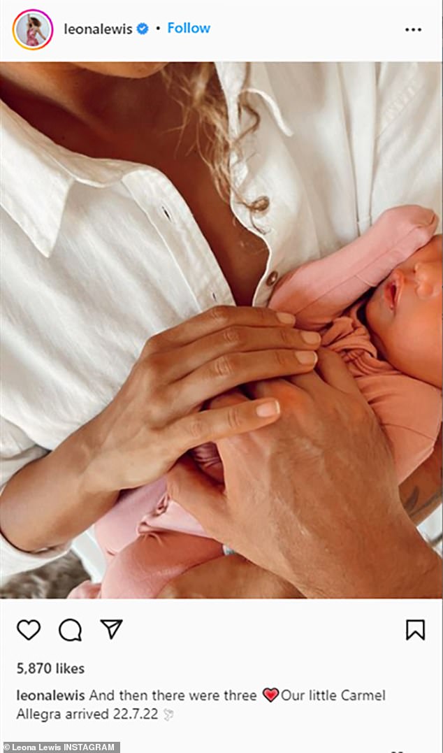 Baby girl: The 37-year-old singer shared a touching snap featuring a partial view of her baby girl, Carmel Allegra, with her and husband Dennis Jauch's hands gently placed over the newborn