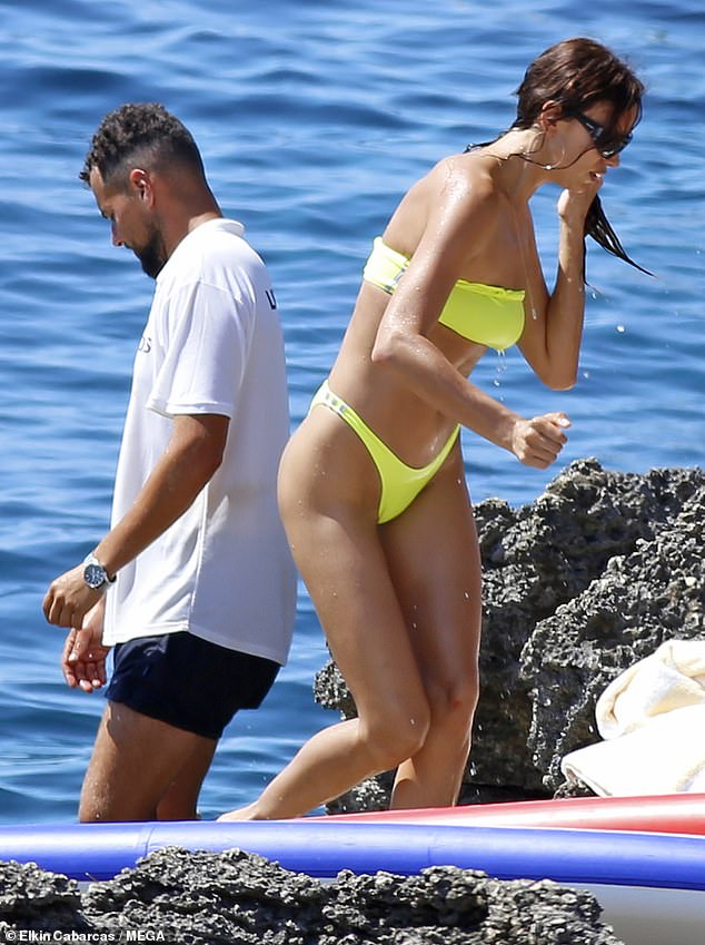 Incredible: The thong bikini showed off her gym-honed body in all its glory as she topped up her tan in the sunshine