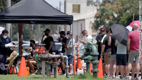 People line up get vaccinated against the monkeypox virus last month at the Ted Watkins Memorial Park in Los Angeles. 