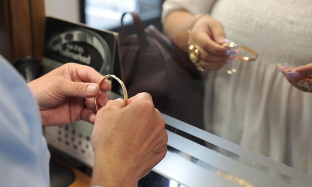 Finch examines a customer’s jewellery