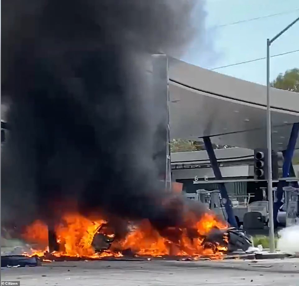 The Mercedes races past a gas station then smashes into the side of a traffic jam, causing a flaming inferno in the Windsor Hills district