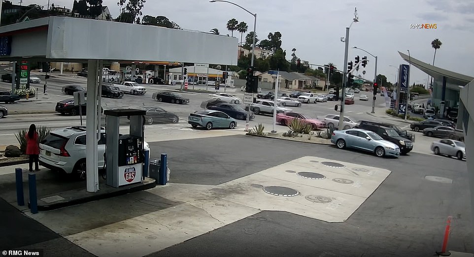 The Mercedes coupe can be seen speeding past the gas station toward the intersection before the sickening crash on Wednesday