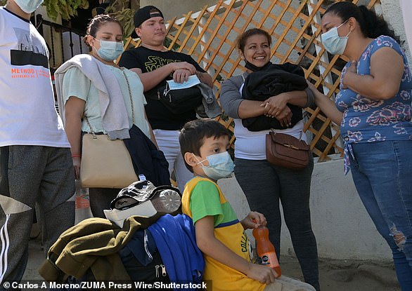 Families wait in Tijuana during their journey north to the United States