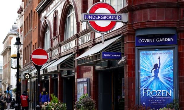 A poster for Frozen: The West End Musical at Covent Garden tube station.