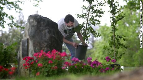 A memorial site at Lindhurst High pays tribute to the victims of the shooting. Here Vincent Furr, a custodian, prepares in 2002 for the 10-year anniversary service. 