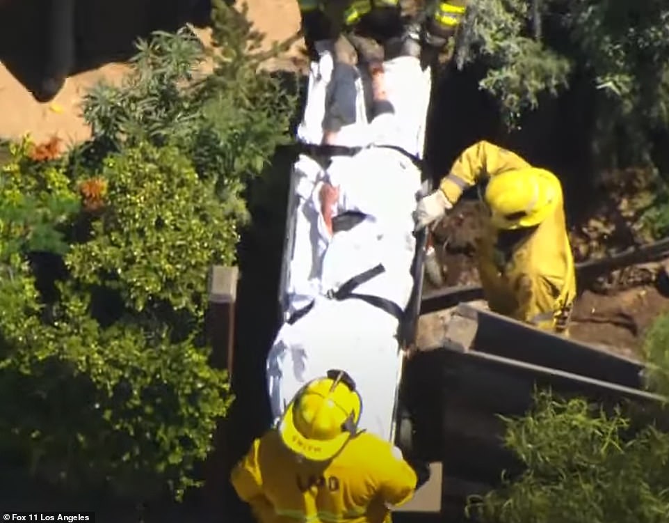 Heche can be seen being removed from the scene on a stretcher and taken towards a waiting ambulance