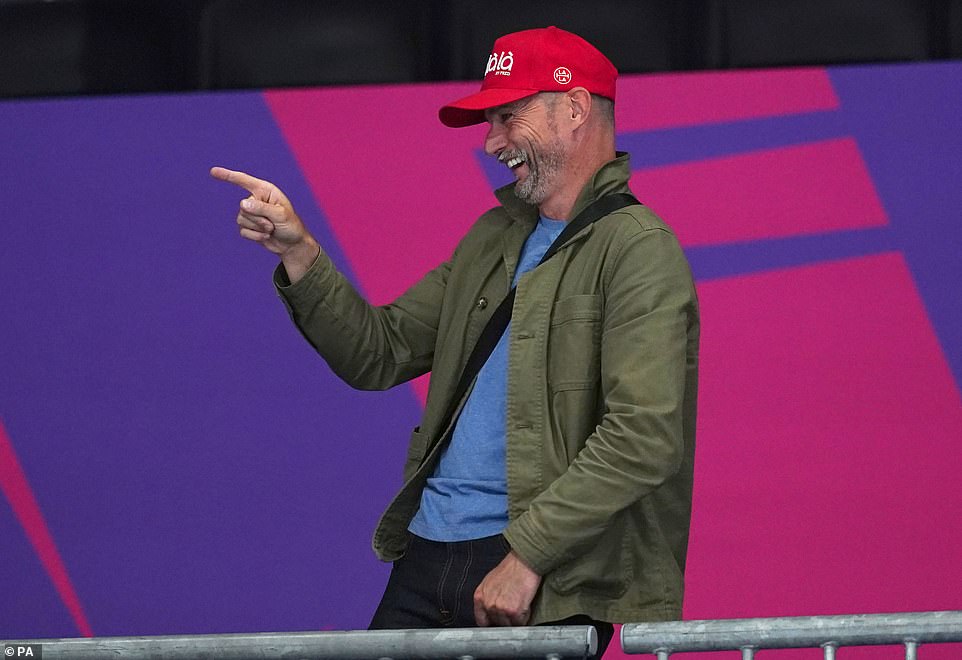 Cheery: Appearing in high spirits, he was snapped laughing with onlookers from the sidelines during the games, which will come to a close on Monday