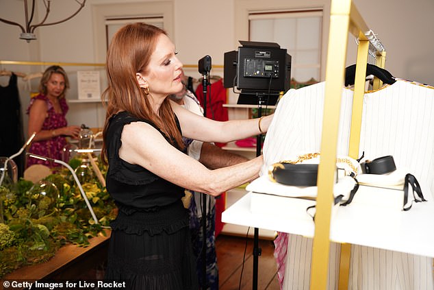 Browsing: The movie star attentively looked through a rack of clothing