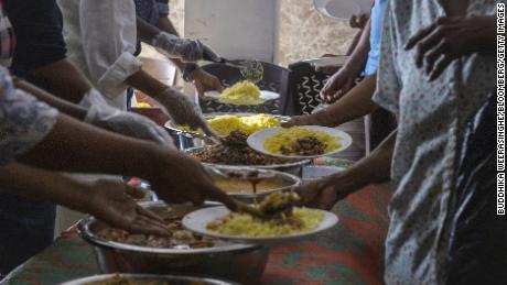 Volunteers serve free meals to people in need at a community kitchen in Colombo, Sri Lanka on Aug. 4.