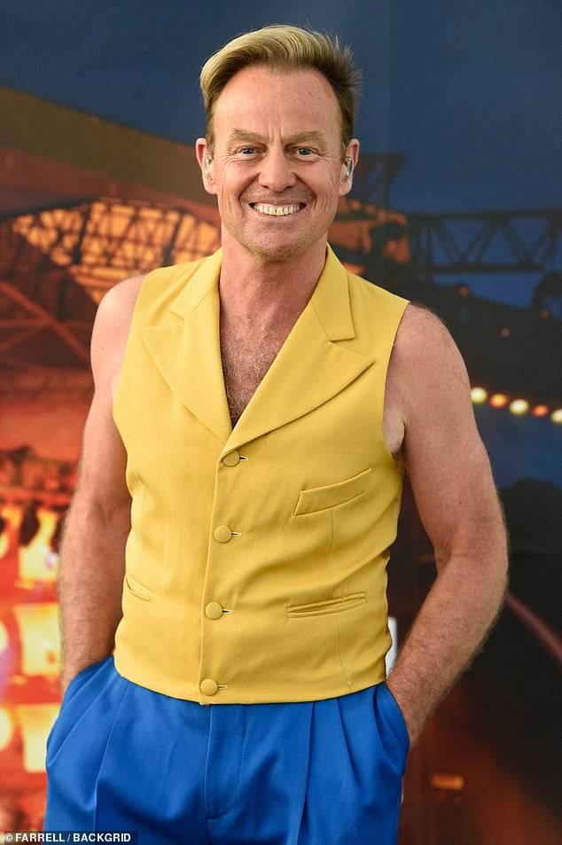 Entertainer: The singer stepped out after his recent appearance in the Neighbours finale, wearing a mustard waistcoat and royal blue trousers