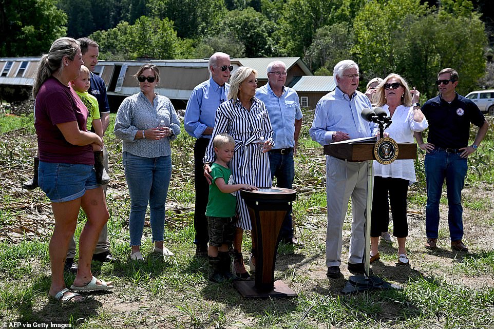 Jill Biden comforts a young boy as she and President Biden listen to Republican Congressman Hal Rogers speak about the storm damage in Kentucky