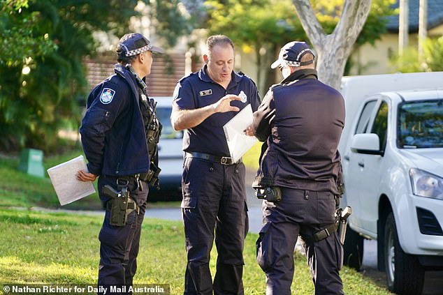 The 49-year-old man charged remains in hospital under police guard and is expected to have a beside court hearing on Tuesday (pictured, police outside the home on Tuesday)