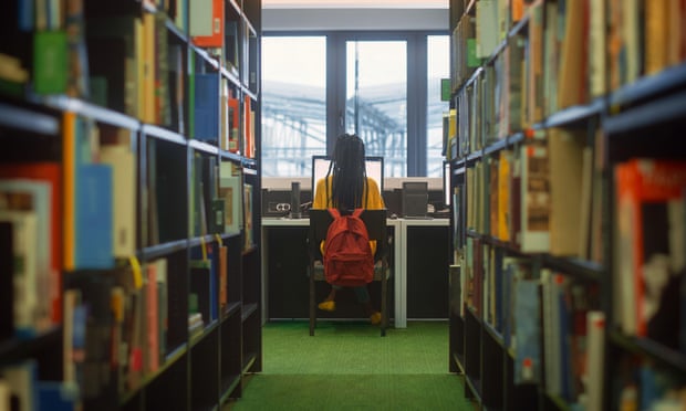 A woman typing in a library