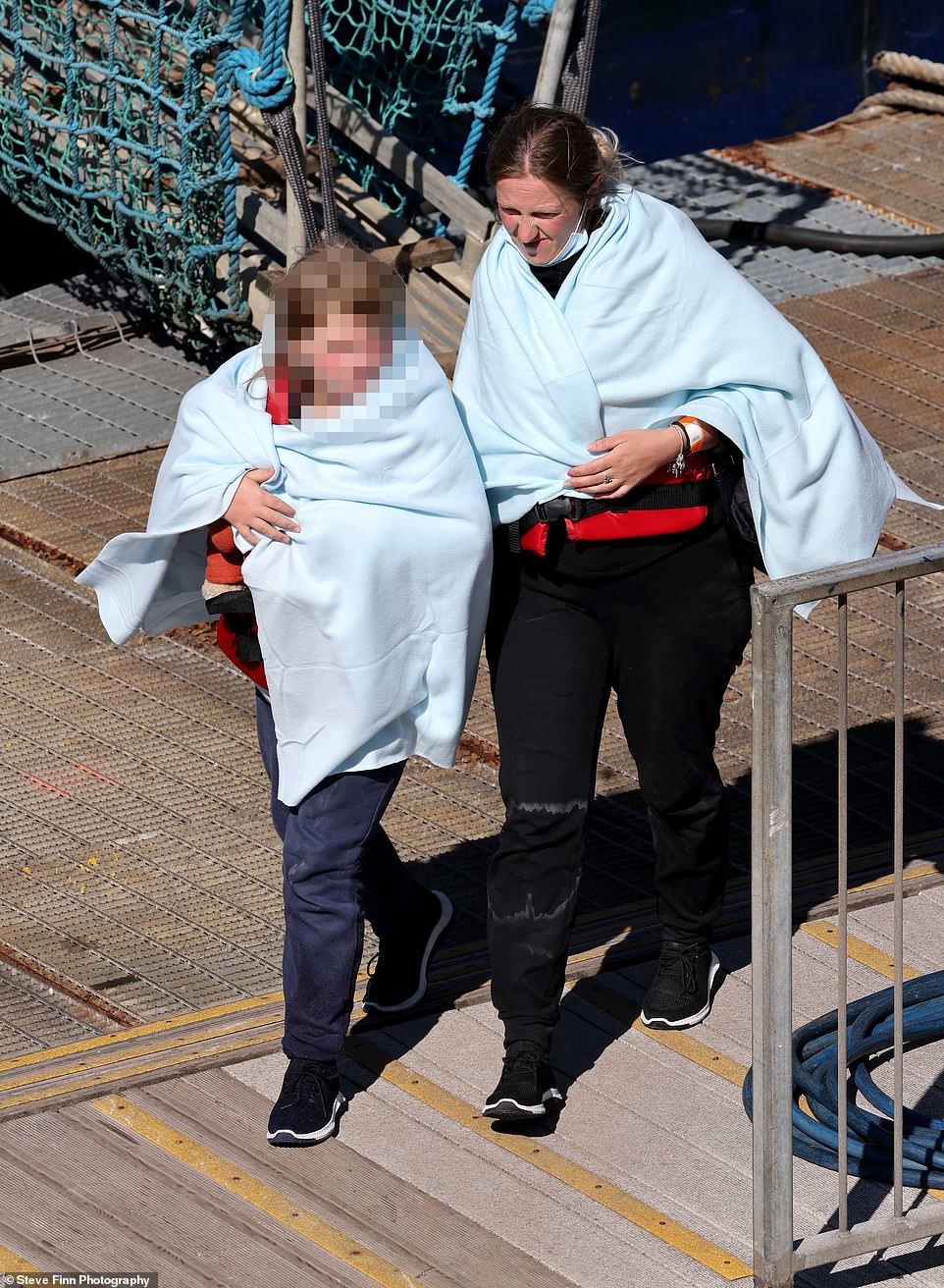 A group of around 50 migrants were escorted ashore into Dover, Kent, this afternoon after being picked up by Border Force in the Channel