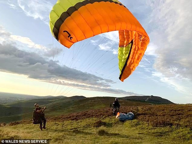 The inquest heard that the father-of-four (pictured here paragliding) was killed by 'multiple injuries' but it had to be adjourned due to insufficient information from the French authorities