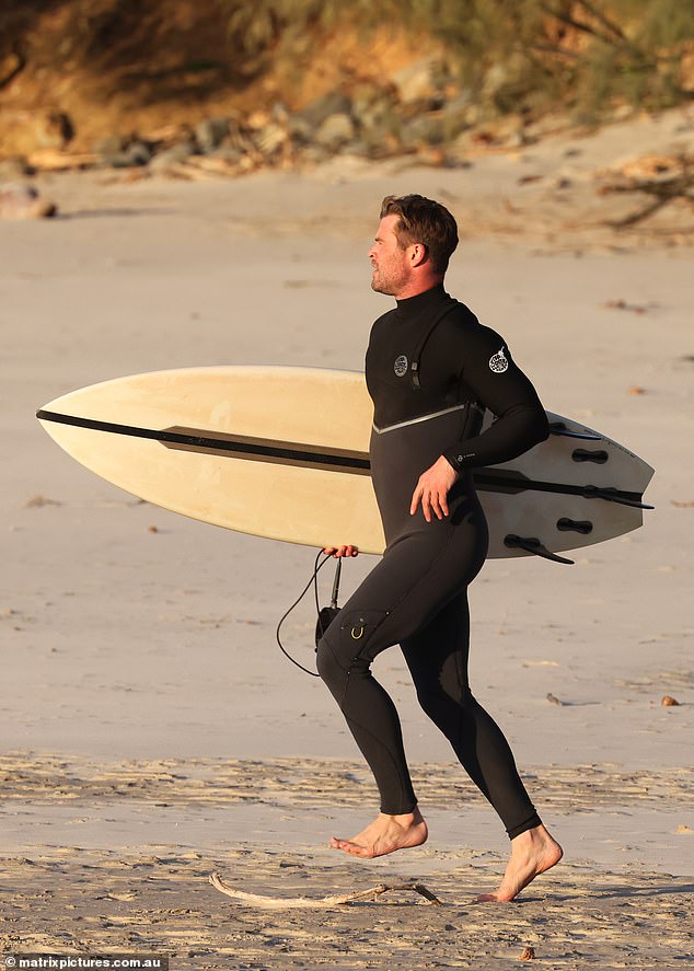 Warm up: Chris ran on the sand as he warmed up for his surf