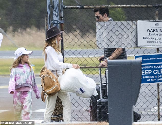 Elsa was carrying three large bags as she walked down the runway, one of which may have contained the birthday boy's present