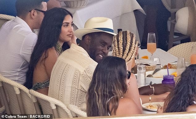 Fun: Diddy looked relaxed as he enjoyed cocktails with pals