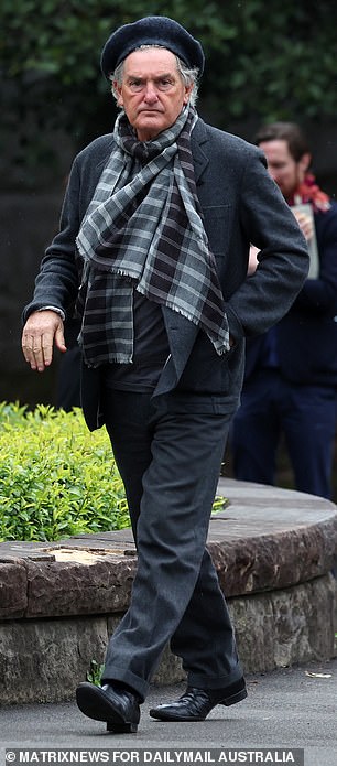 A mourner arrives for the funeral of Di Kershaw