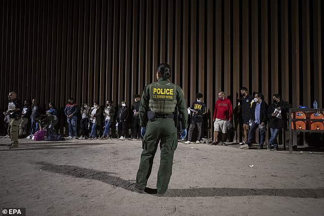 A CBP agent keeps watch on migrants on June 21, in the Yuma sector