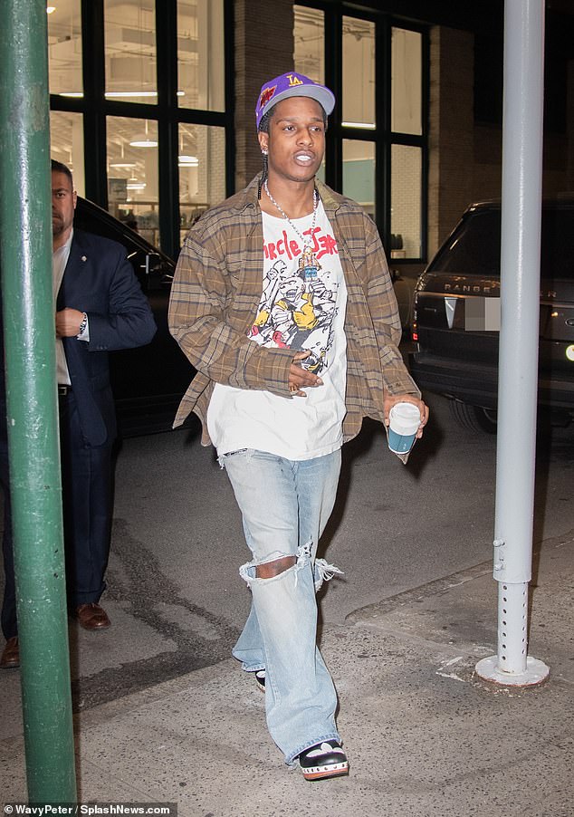 Grunge: He added a brown flannel to the look as well as washed out jeans with giant holes in the knees