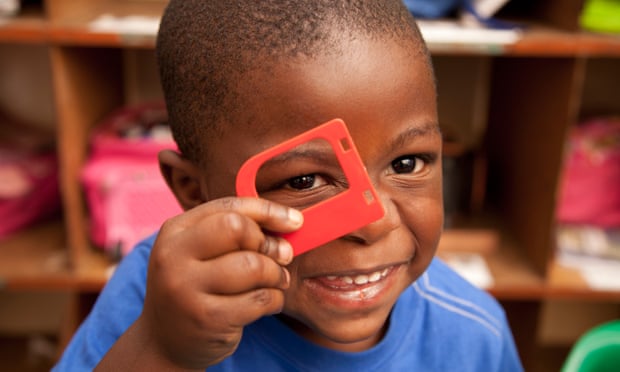 Smiling child looking through toy frame