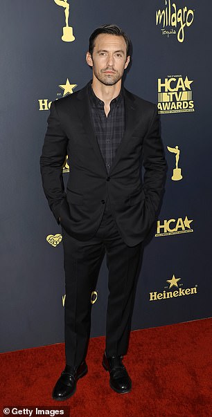 Stylish: Milo Ventimiglia wore a black suit and dark dress shirt underneath as he attended the HCA TV Awards