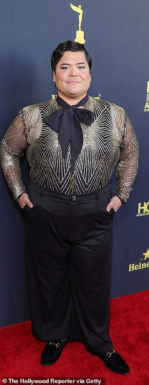 Fashionable: Harvey Guillen pulled off a black and gold sequin shirt and black dress pants for his red carpet look