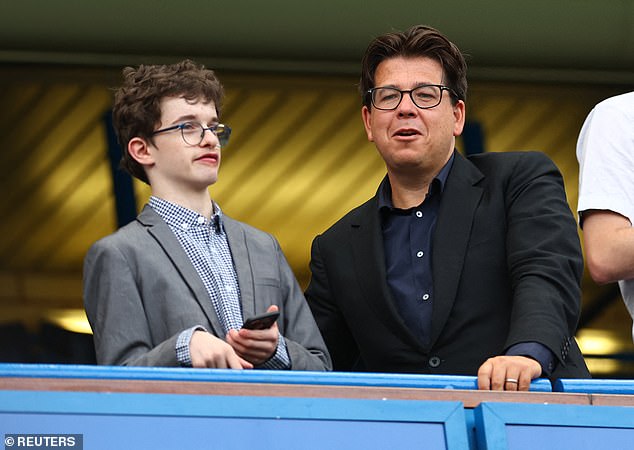 Looking good: The comedian, 46, cut a dapper figure in a black suit jacket and a navy shirt, while wearing a pair of glasses