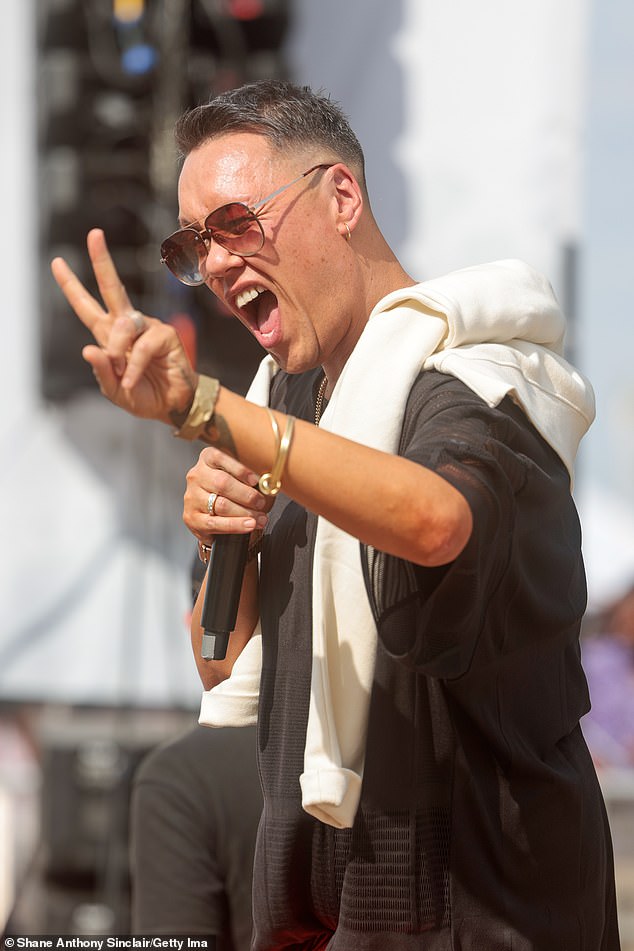 Showtime: The presenter beamed as he took to the stage holding up a peace sign at the crowd at the Queen Elizabeth Olympic Park