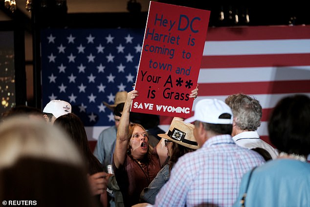 Mary Fichtner, Hageman's college best friend who has volunteered with the campaign, holds a poster during the primary election night party of the GOP winner