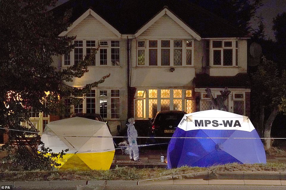 Officers at the scene in the early hours of this morning. Evidence tents covered the victim's mobility scooter and his body