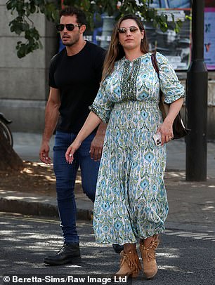 Don't mind me: Kelly was two steps ahead of her husband as they ventured out for a stroll