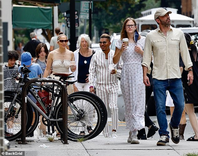 Taking it easy: Jennifer Lopez and her child Emme brought up the rear while wearing a hypnotizing black-and-white patterned sweater with white shorts, while they wore their hair in short curls