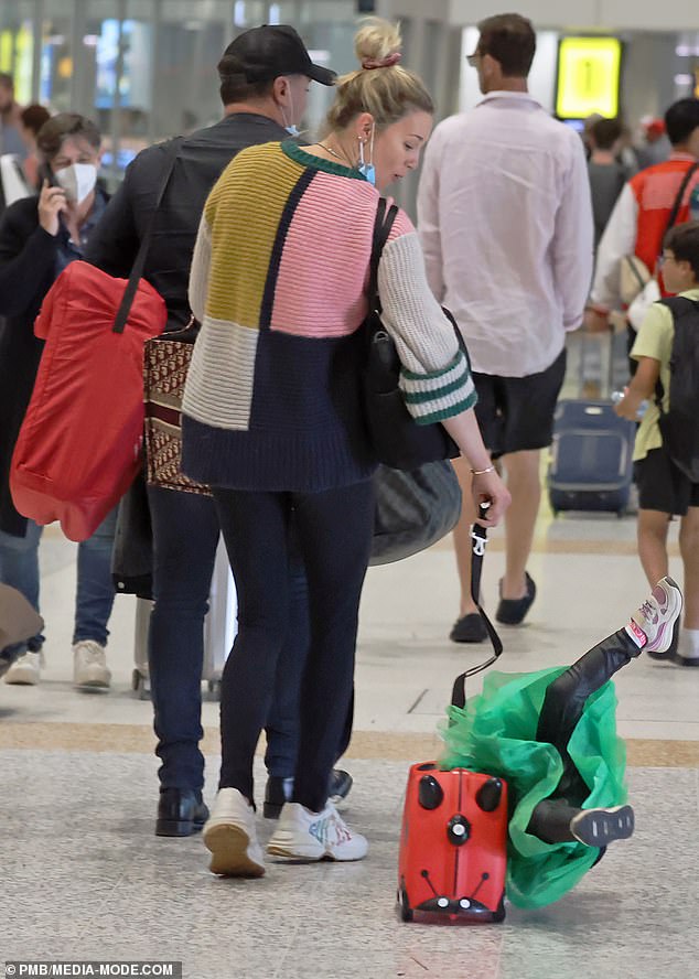 Little Harper appeared to have slipped off the side of the bag, before landing on the floor