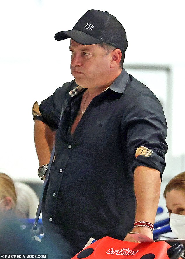 Karl, who grew up in Queensland, went for a casual look in a black Burberry buttoned-up shirt and jeans. He also rocked an IJE cap - the name of billionaire James Packer's $200 million yacht