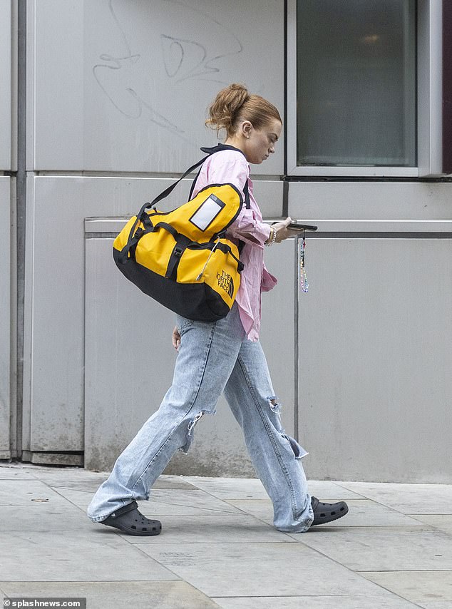 Low-key: The EastEnders star, 21, cut a casual figure in a pair of blue ripped jeans, a pink shirt and a pair of black crocs