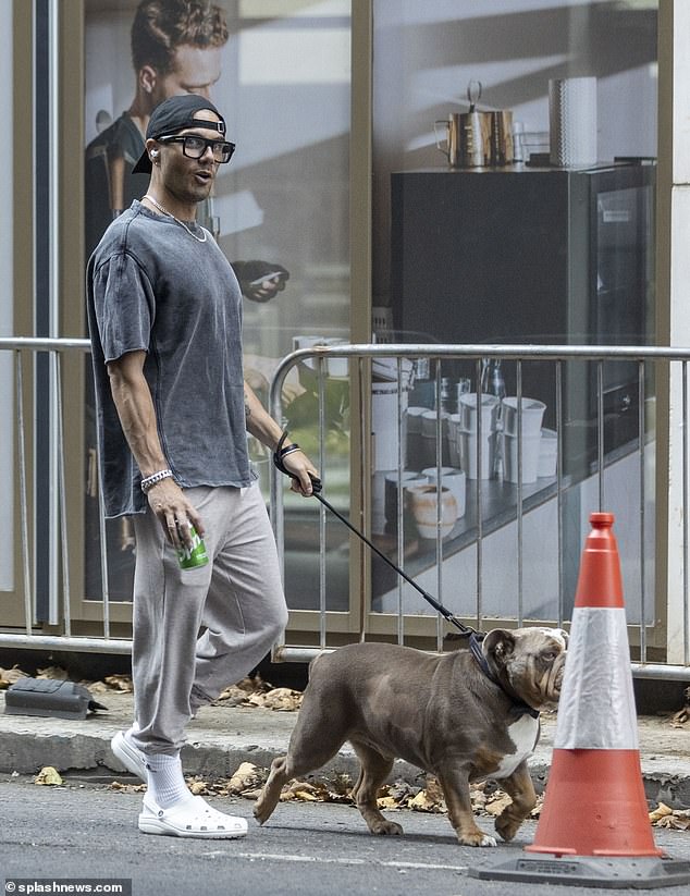 Casual: Max, 33, looked effortlessly cool in a grey t-shirt, beige joggers and a pair of white crocs