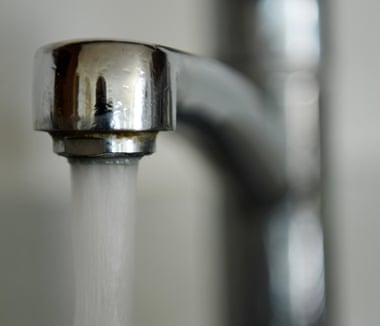 Water pours from a tap in a home